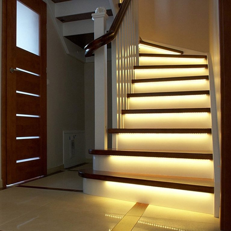 Indoor staircase with warm white LED strip lighting under each stair tread