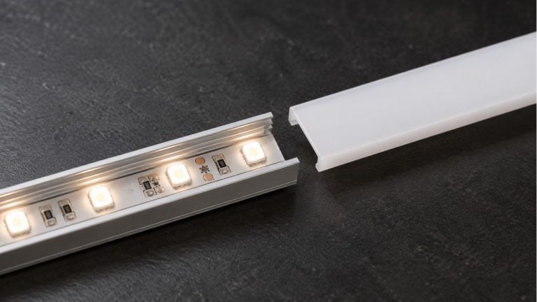 LED tape inside an aluminum channel with its opal diffuser cover partly removed.