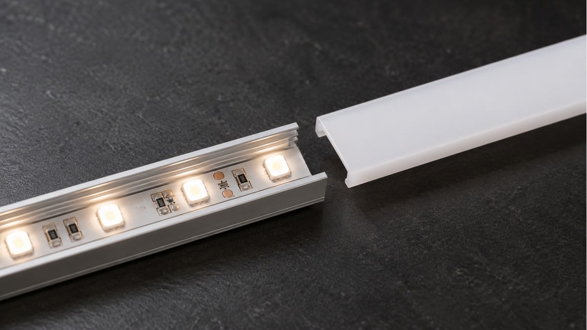 LED tape inside an aluminum channel with its opal diffuser cover partly removed.