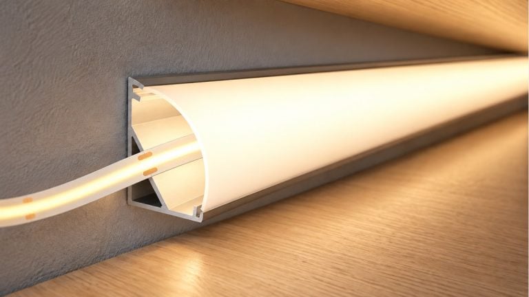 Warm white COB LED strip entering an aluminum corner channel with an opal diffuser.