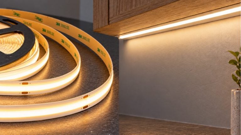 Warm-white COB LED tape with yellow adhesive backing beside an under-cabinet lighting example.