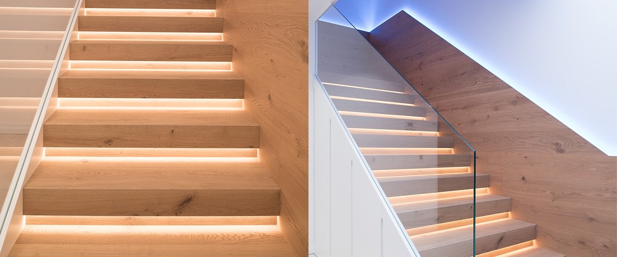 LED stair lights under wooden steps with a glass rail