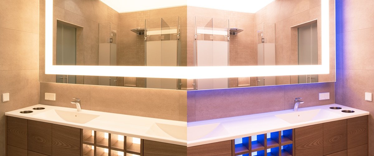 Bathroom mirror backlit with LED strip plus blue accent lighting in the niches