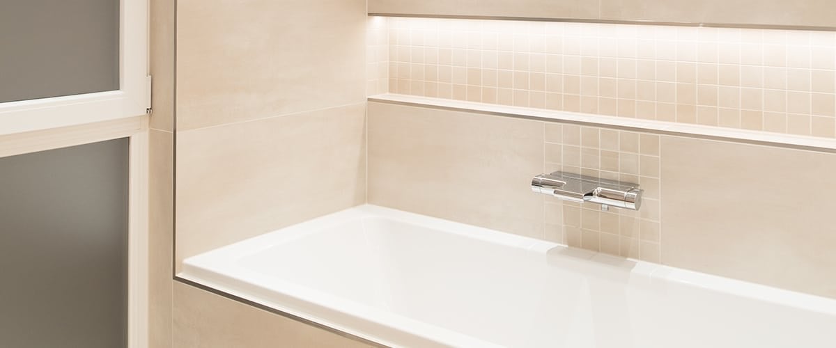 Bathroom mirror and vanity lit by a white LED strip