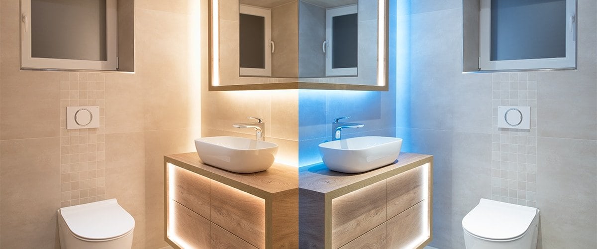 Bathroom vanity lit by LED strip with a blue accent