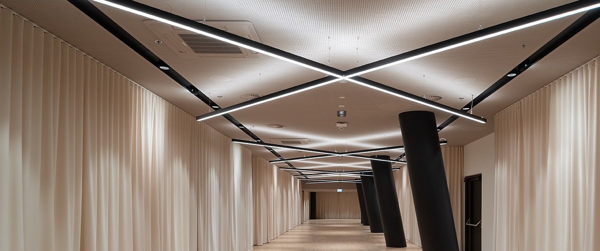 Corridor ceiling with crossing LED strip lines
