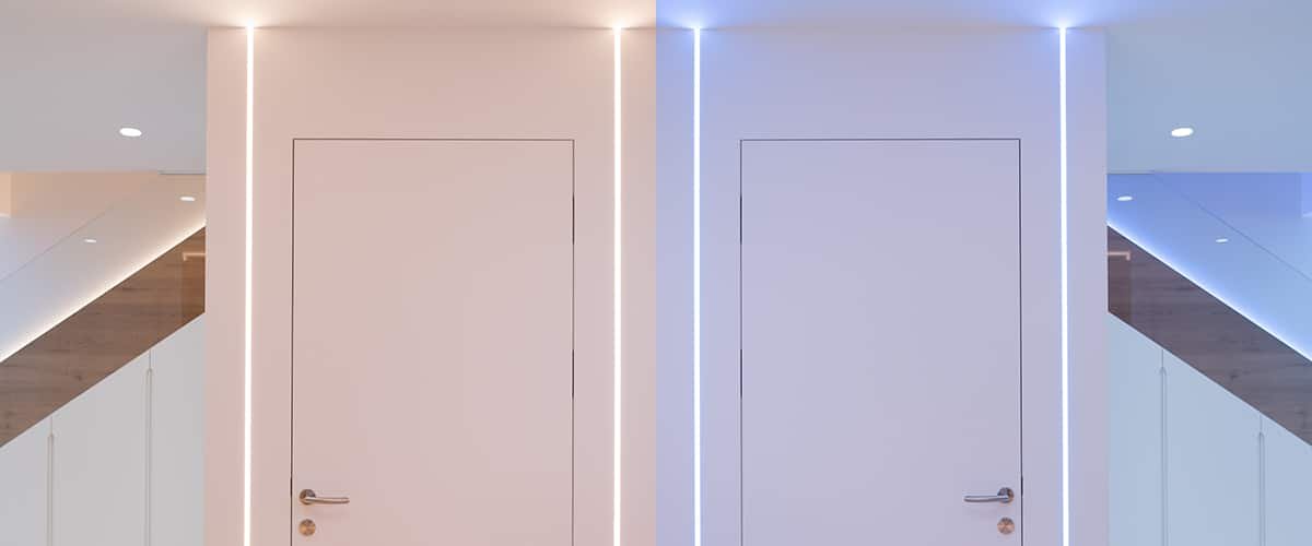 Recessed LED strip outlining door frames in a white hallway
