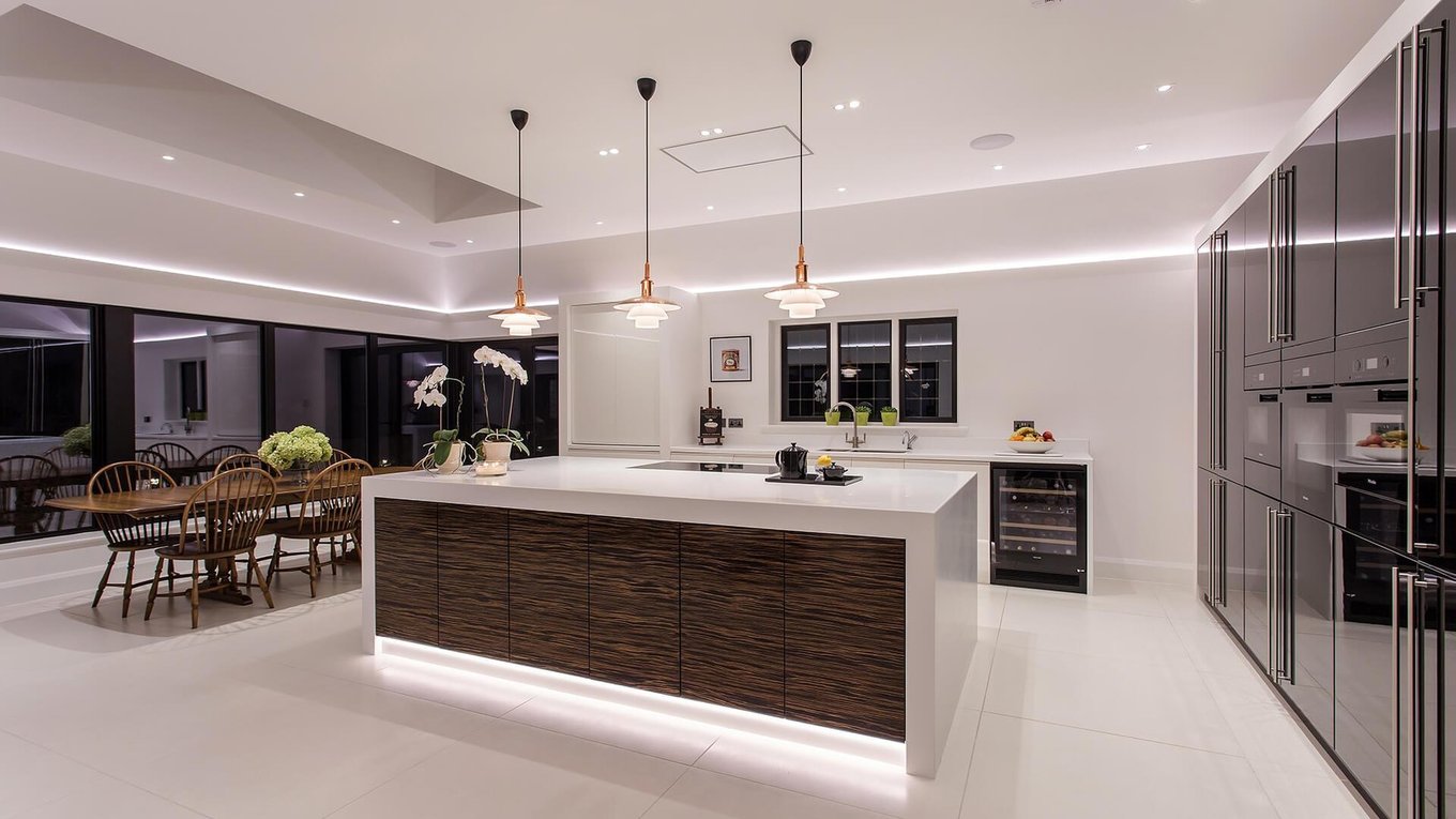 LED strip lighting in a modern kitchen: ceiling cove and island underlighting