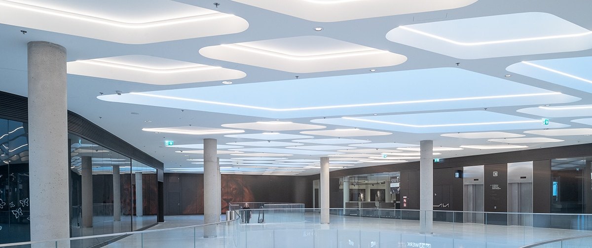 Shopping mall ceiling panels backlit with LED strip
