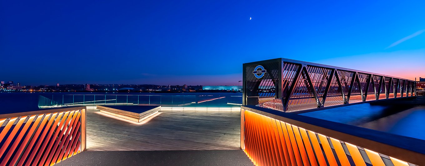 Waterfront pier walkway lit with warm LED strip at dusk