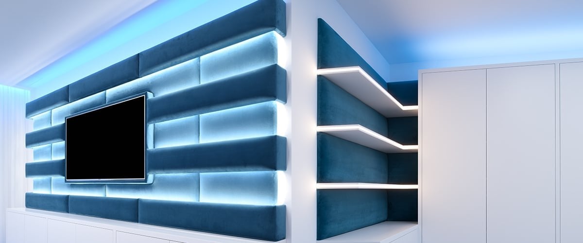 TV wall with LED strip lit shelves in blue