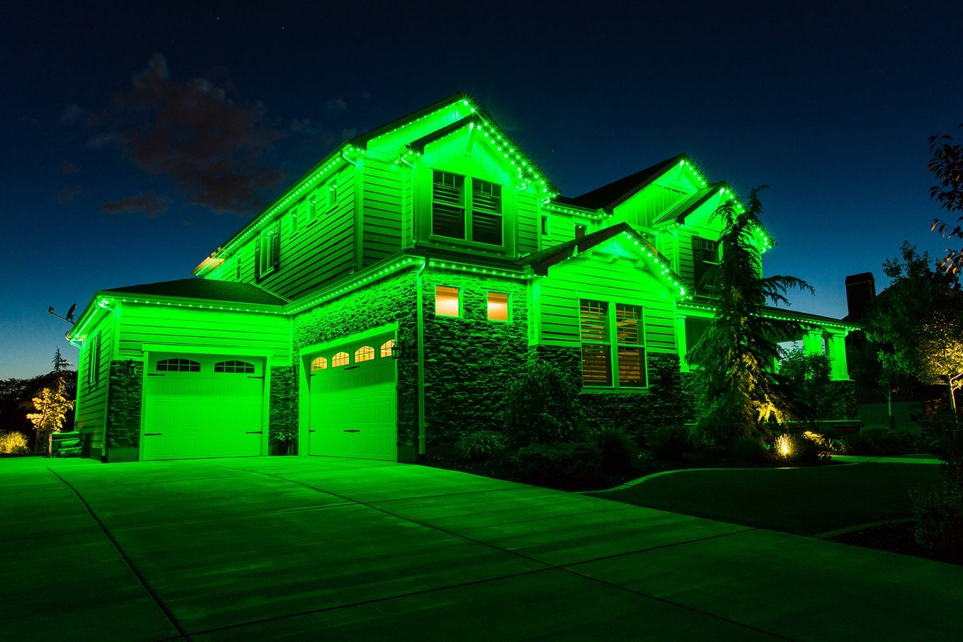 House exterior with permanent colour-changing LED roofline lights in green