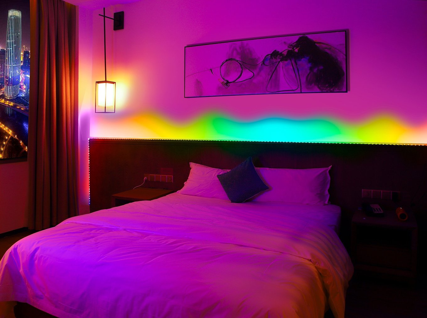 Addressable RGB LED strip behind a bed headboard creating a colour gradient