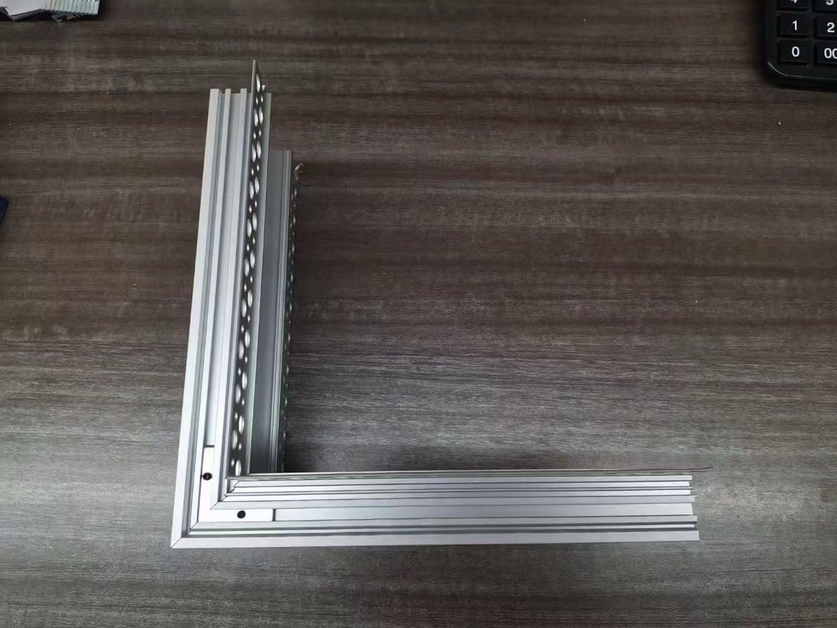 Custom 90 degree corner cut on a trimless plaster-in LED aluminium profile, two mitred sections joined into a right angle