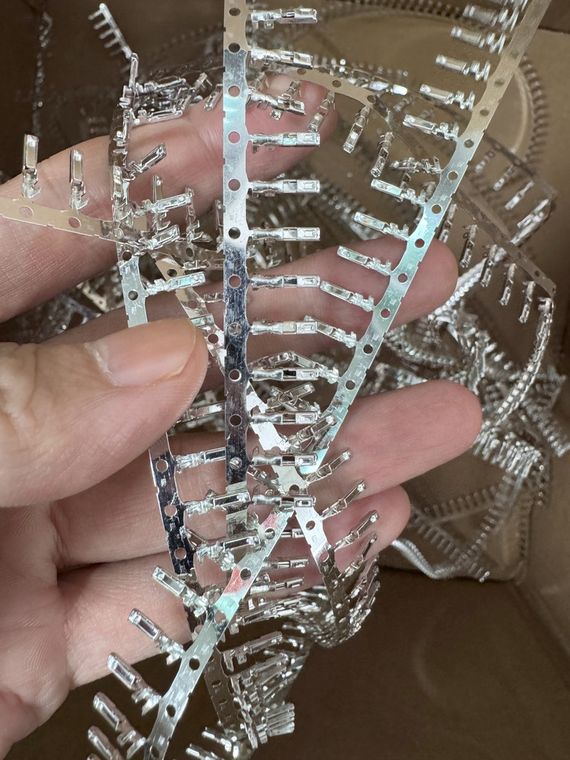 Reel of crimp terminals for LED strip light connector assemblies