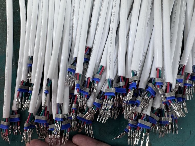 Crimped terminals on 22 AWG four-core cable for an LED strip light assembly