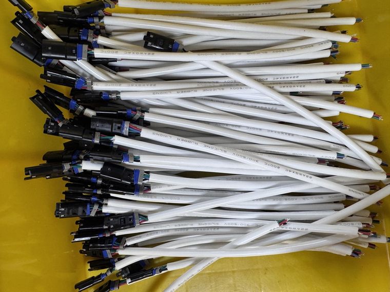 LED strip light connector housings fitted onto crimped terminals on white cable