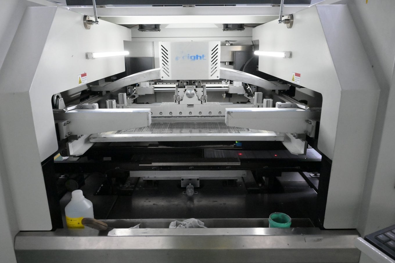 Inside the stencil printer applying solder paste to flexible LED strip PCB panels