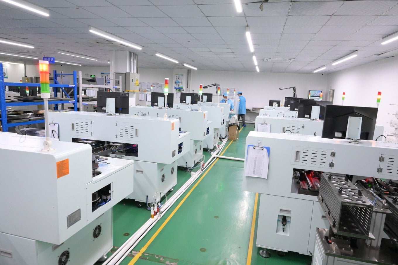 Row of SMT and reflow machines on the production floor