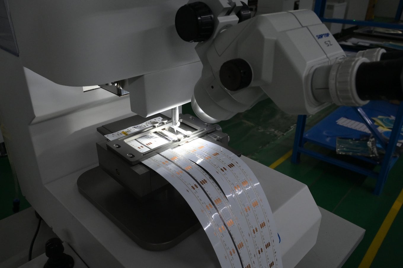 Pull tester and microscope checking solder joints on an LED strip